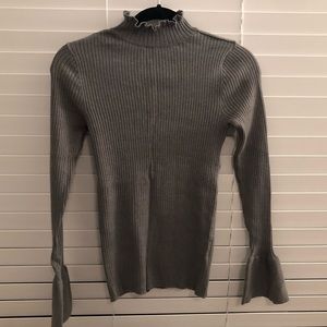Gray turtleneck with trumpet sleeves